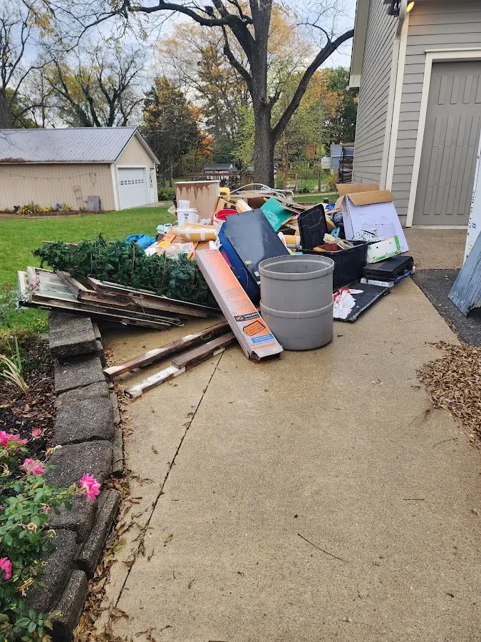 Dumpster being loaded with debris for Estate Cleanout Dumpster Rental in Weslaco